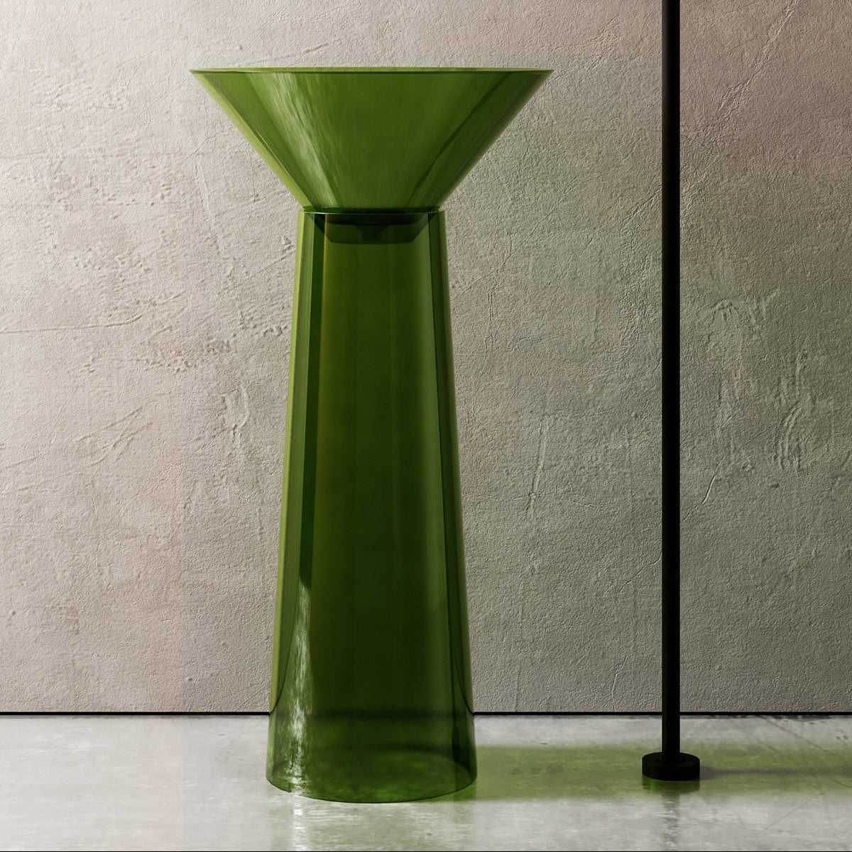 Green freestanding sink with black faucet against a neutral wall.