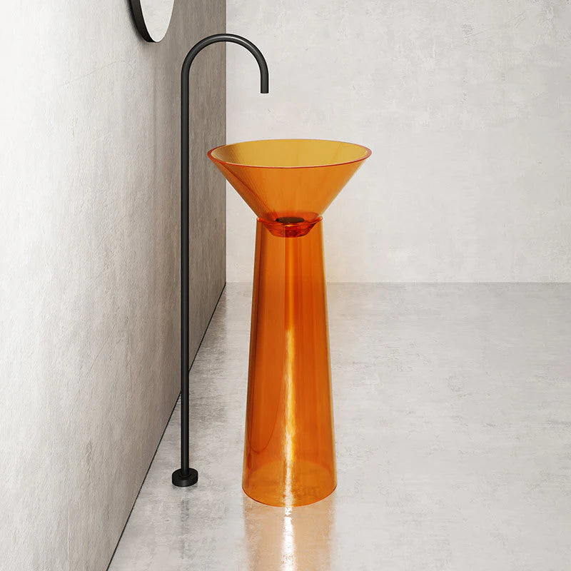 Orange pedestal sink against a neutral wall