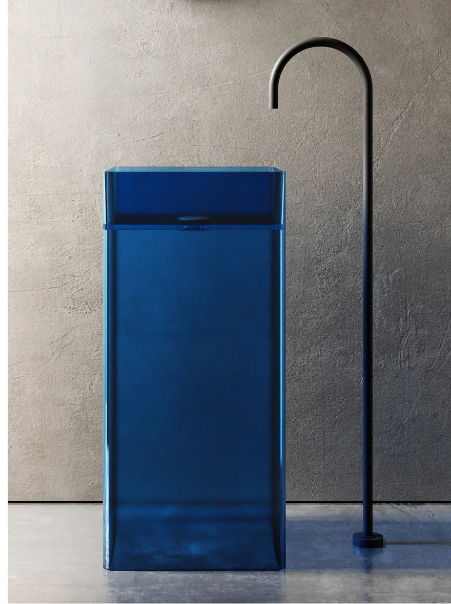 Blue freestanding sink with a black faucet against a gray wall.