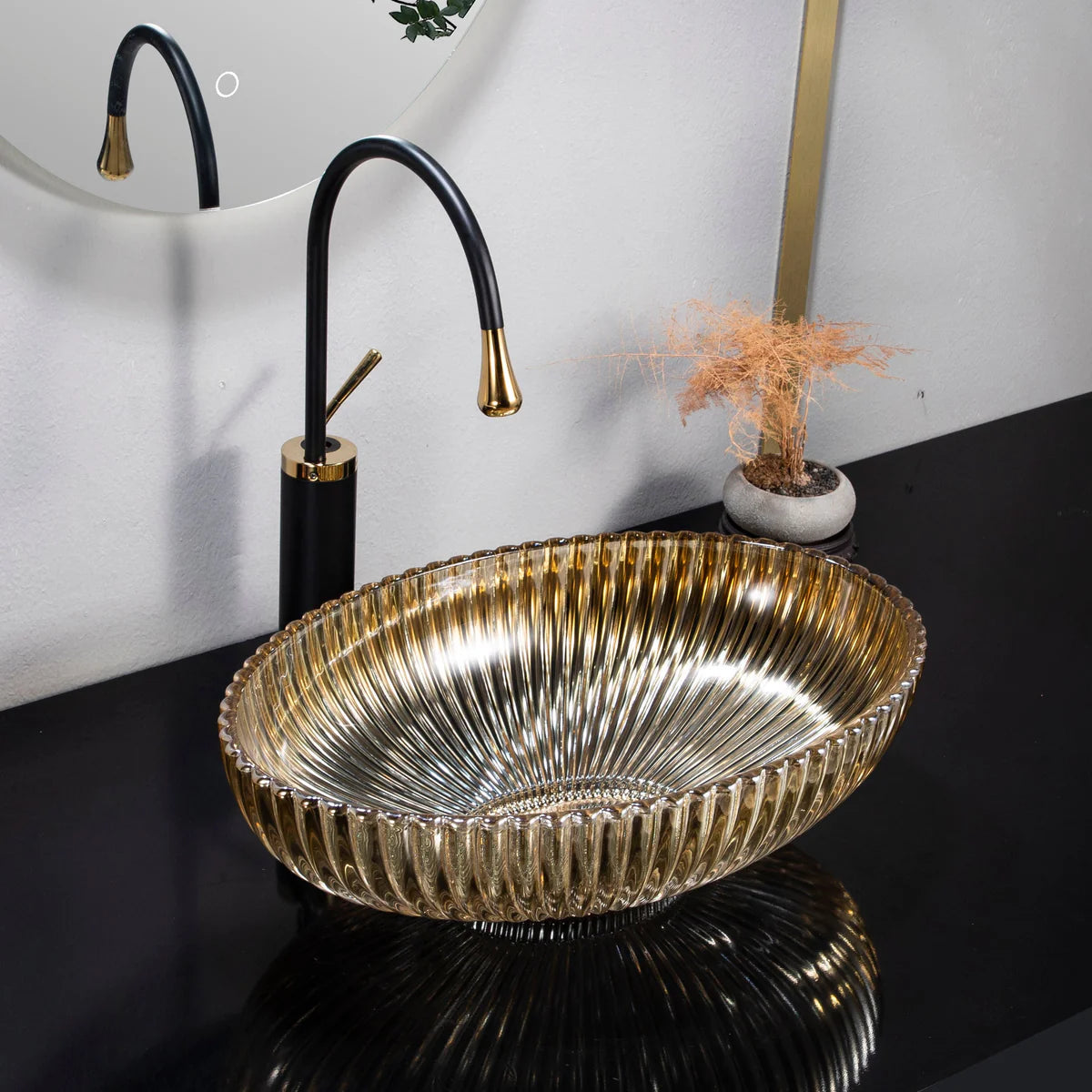 Gold sink basin with black faucet in a bathroom setting
