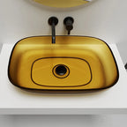 Yellow glass sink with black faucet on a white countertop